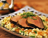 Slices of roast beef on couscous