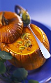 Pumpkin and tomato soup with leeks in hollowed-out pumpkin