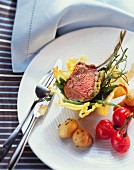 Lamb chop in Parmesan bowl with vegetables and rosemary