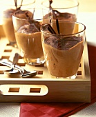 Chocolate mousse in glasses on wooden tray