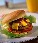Chili cheeseburger with ketchup, tomatoes and lettuce