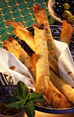Stuffed yufka pastry sticks (Sigara Boeregi) with olives