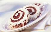 Chocolate roll with cream and chocolate powder