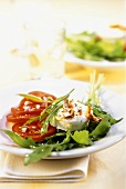 Rocket and tomato salad with fried goat's cheese