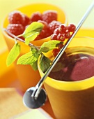 Cool berry soup in yellow beaker