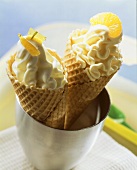 Lime quark ice cream and orange ice cream in cones