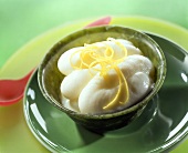 Lemon grass ice cream with lemon zest in green bowl
