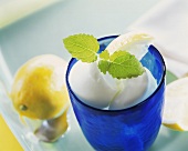 Lemon ice cream with lemon balm in blue glass