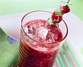Raspberry and blueberry drink with ice cubes