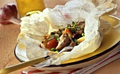 Lamb with vegetables and thyme in baking paper