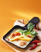 Raclette with shrimps, corncobs, tomatoes and chili