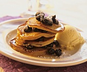 Pancakes with berries, icing sugar and vanilla ice cream