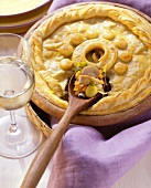 Poultry pie with filling on spoon
