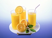 Three glasses of orange juice on tray