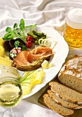 Hearty snack with ham, cheese, bread and beer
