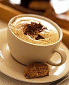 Cup of cappuccino with chocolate leaves & amaretti
