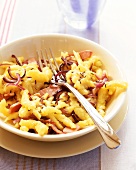 Home-made ham and onion noodles (spaetzle) with caraway