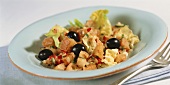 Bread salad with black olives and pepper flakes