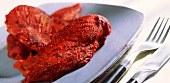 Barbecued Tandoori chicken fillets on blue plate