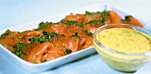 Sliced, marinated salmon trout with mustard sauce
