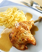 Chicken leg with ribbon noodles and sauce