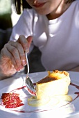 Woman eating a piece of cheesecake