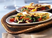 Taco shells with vegetable filling, soft cheese & peanuts