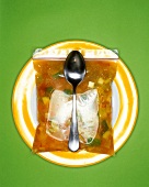 Vegetable soup in plastic bag with spoon