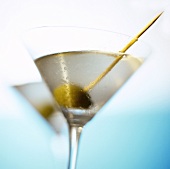 Martini with green olive and toothpick