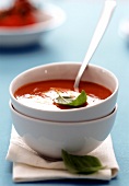 Tomato soup with basil in soup bowl
