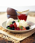 Vanilla ice cream with berries and lemon balm