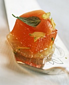 Blood orange jelly on grapefruit slice, decorated with papaya