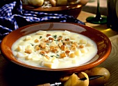 Potato soup with croutons and herbs