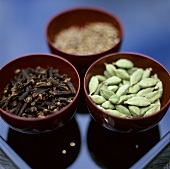 Cloves and cardamom in bowls