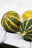 Three green and yellow squashes