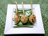 Asian chicken and lemon grass kebabs on beans