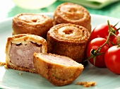 Small pork pies and fresh tomatoes