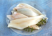 Fresh lemon sole fillets on plate