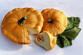 Patty pan squashes, one with a piece cut off