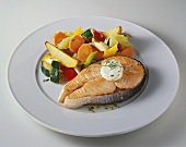 Salmon steak with vegetables and herb butter