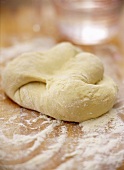 Dough with flour on chopping board