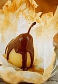 Poached pear with chocolate sauce in filo pastry