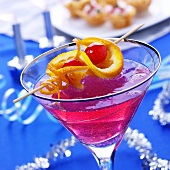 Pink cocktail with champagne & skewered fruit for Christmas