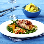 Stuffed chicken breast with bacon and vegetables