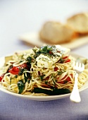 Spaghetti with vegetables, mint and goat's cheese