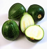 Round courgettes, one cut open