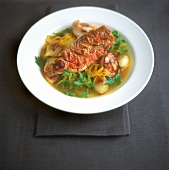 Red mullet with onions and peppers in saffron sauce