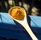 Ground turmeric on spoon