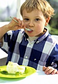 Small boy eating dessert