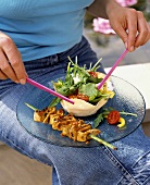 Eating by the pond: barbecued sate with salad